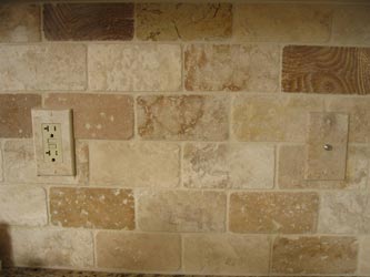 Installed travertine light switch cover plate